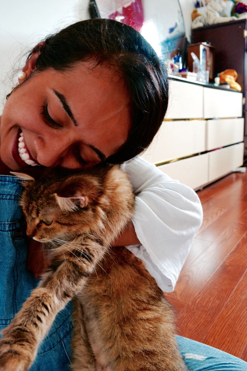 Photo of Werdah holding a cat.